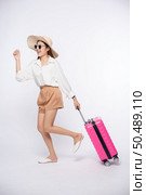 Woman wearing a hat, glasses, and handles of suitcases to travel. Стоковое фото, агентство Ingram Publishing / Фотобанк Лори