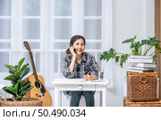 Women sit at the desk and use the phone to coordinate. Стоковое фото, агентство Ingram Publishing / Фотобанк Лори