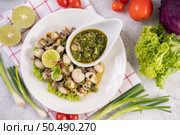Spicy Squid Salad with White Platter with Spring Onion, Chili, Lime and Tomato. Стоковое фото, агентство Ingram Publishing / Фотобанк Лори