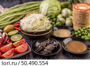 Papaya salad ingredients include papaya, pickled crab, eggplant, tomato, lime, chili, garlic and fermented fish. Стоковое фото, агентство Ingram Publishing / Фотобанк Лори