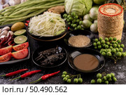 Papaya salad ingredients include papaya, pickled crab, eggplant, tomato, lime, chili, garlic and fermented fish. Стоковое фото, агентство Ingram Publishing / Фотобанк Лори