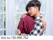 Two men who love each other happily hug each other. Стоковое фото, агентство Ingram Publishing / Фотобанк Лори
