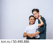 Two female lovers standing and hugging from behind. Стоковое фото, агентство Ingram Publishing / Фотобанк Лори