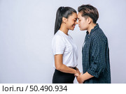 Women couples stand and fragrant cheek. Стоковое фото, агентство Ingram Publishing / Фотобанк Лори
