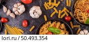 Macaroni sauteed with tomatoes and basil on the pan. Стоковое фото, агентство Ingram Publishing / Фотобанк Лори