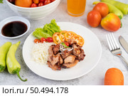 Grilled pork cutlet with tomatoes and salad, arranged in a white dish. Стоковое фото, агентство Ingram Publishing / Фотобанк Лори