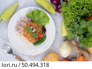 Stir-fried noodles with minced pork, edamame, tomatoes and mushrooms in a white plate. Стоковое фото, агентство Ingram Publishing / Фотобанк Лори