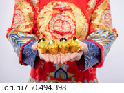 Man wear Cheongsam suit  give gold to his relative for lucky in chinese new year. Стоковое фото, агентство Ingram Publishing / Фотобанк Лори