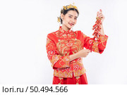 Woman wear Cheongsam suit smile to get Firecrackers from boss in chinese new year. Стоковое фото, агентство Ingram Publishing / Фотобанк Лори