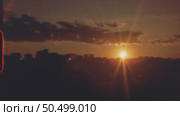 8 mm - sunset light bathing metropolitan skyline in warm orange hues, vintage light leak rendering nostalgic urban landscape with soft glowing atmosphere. Стоковое видео, видеограф Данил Руденко / Фотобанк Лори