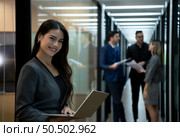 New business group person in the corridor of the conference room, Rehearse information to present results and new projects to the management team for consideration. Стоковое фото, агентство Ingram Publishing / Фотобанк Лори