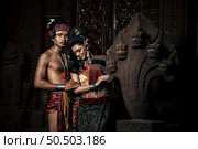 Young Actor and Actress wearing beautiful ancient costumes, in ancient monuments, dramatic style. Perform on legend love popular story, Thai Isan folktale called "Phadaeng and Nang-ai" in acient site. Стоковое фото, агентство Ingram Publishing / Фотобанк Лори