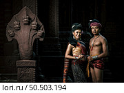 Young Actor and Actress wearing beautiful ancient costumes, in ancient monuments, dramatic style. Perform on legend love popular story, Thai Isan folktale called "Phadaeng and Nang-ai" in acient site. Стоковое фото, агентство Ingram Publishing / Фотобанк Лори
