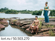 Portrait of Young man and woman wearing beautiful traditional costume which Imagination image of Thailand literature about Serpent king, Folk tales based on belief of the Isan, pose in nature outdoors. Стоковое фото, агентство Ingram Publishing / Фотобанк Лори