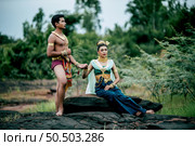 Portrait of Young man and woman wearing beautiful traditional costume which Imagination image of Thailand literature about Serpent king, Folk tales based on belief of the Isan, pose in nature outdoors. Стоковое фото, агентство Ingram Publishing / Фотобанк Лори