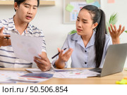 Male and female employees working together and having stress in the office. Стоковое фото, агентство Ingram Publishing / Фотобанк Лори