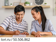 Male and female employees work together happily in the office. Стоковое фото, агентство Ingram Publishing / Фотобанк Лори