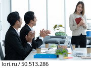 Young asian woman freshmen in the new generation of entrepreneurs team. Successfully presented the project to the satisfaction of the management. Стоковое фото, агентство Ingram Publishing / Фотобанк Лори