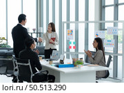 Young asian woman freshmen in the new generation of entrepreneurs team. Successfully presented the project to the satisfaction of the management. Стоковое фото, агентство Ingram Publishing / Фотобанк Лори