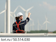 Engineer at Natural Energy Wind Turbine site with a mission to climb up to the wind turbine blades to inspect the operation of large wind turbines that converts wind energy into electrical energy. Стоковое фото, агентство Ingram Publishing / Фотобанк Лори