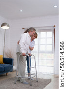 Old couple with her husband, who had to learn to walk after being treated for an osteoarthritis. Must help and take care of each other without children to take care of. Стоковое фото, агентство Ingram Publishing / Фотобанк Лори