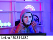 This is the face of a hacker who is knowledgeable with operating systems and other programs. He will exploit flaws and breach the computer system to cause damage. Стоковое фото, агентство Ingram Publishing / Фотобанк Лори