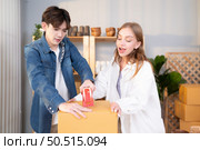 A young couple runs a small business making clay jewelry. They support one another as they work toward becoming larger business in the future. Стоковое фото, агентство Ingram Publishing / Фотобанк Лори