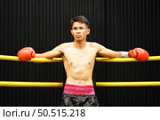 Muay Thai, The martial art of Thailand, Boxer sitting in the corner When the referee stops the fight in each round for the boxer to rest and the coach to introduce the fight in the next round. Стоковое фото, агентство Ingram Publishing / Фотобанк Лори