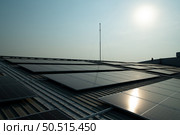 Solar farm on roof and sunset Solar modules for renewable energy technology that people have access to. Стоковое фото, агентство Ingram Publishing / Фотобанк Лори
