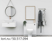 Bathroom with washbasin with bathrobes and wall mounted photo frame. Стоковое фото, агентство Ingram Publishing / Фотобанк Лори