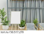 Picture frames with plant pots adorn the living room. Стоковое фото, агентство Ingram Publishing / Фотобанк Лори