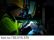 The technician must use bright lights and a magnifying glass to check the detail of the workpiece. the 3D printer’s printout. Стоковое фото, агентство Ingram Publishing / Фотобанк Лори