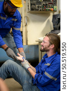 Working in a large industrial facility with heavy materials and machinery. Safety considerations are therefore of the utmost significance. Extreme vigilance must be exercised in this situation. Стоковое фото, агентство Ingram Publishing / Фотобанк Лори