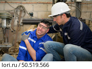Working in a large industrial facility with heavy materials and machinery. Safety considerations are therefore of the utmost significance. Extreme vigilance must be exercised in this situation. Стоковое фото, агентство Ingram Publishing / Фотобанк Лори