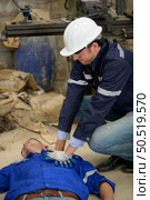 Working in a large industrial facility with heavy materials and machinery. Safety considerations are therefore of the utmost significance. Extreme vigilance must be exercised in this situation. Стоковое фото, агентство Ingram Publishing / Фотобанк Лори