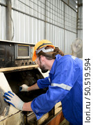 Working in a large industrial facility with heavy materials and machinery. Safety considerations are therefore of the utmost significance. Extreme vigilance must be exercised in this situation. Стоковое фото, агентство Ingram Publishing / Фотобанк Лори