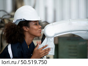 Portrait of a young female engineer in the welding robot industry, posed like a top model. Стоковое фото, агентство Ingram Publishing / Фотобанк Лори