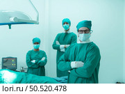 Portrait of professor of medicine in cardiology and a team of doctors in the operating room undergoing heart transplant surgery. Стоковое фото, агентство Ingram Publishing / Фотобанк Лори