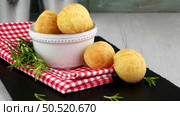 Brazilian cheese buns over red towel on wooden table. Стоковое фото, агентство Ingram Publishing / Фотобанк Лори