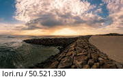 View of the seawall south of Furadouro beach in Ovar on a stormy day at sunset. Стоковое фото, агентство Ingram Publishing / Фотобанк Лори