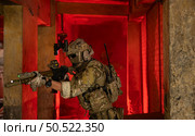 Soldier in anti-terrorist warfare in a dark building, Anti-terrorist operation training on the battlefield. Стоковое фото, агентство Ingram Publishing / Фотобанк Лори