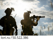 Soldier holding gun and showing action success or war win, special forces military training concept. Стоковое фото, агентство Ingram Publishing / Фотобанк Лори