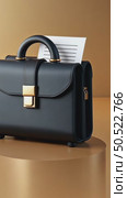 A modern 3D briefcase icon with a matte black finish and gold accents, slightly open to show documents inside, professional aesthetic of business negotiations. Стоковое AI-видео, аниматор Sergey Grishin / Фотобанк Лори