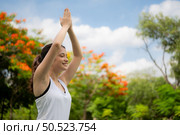 Young female with outdoor activities in the city park, Yoga is her chosen activity. Стоковое фото, агентство Ingram Publishing / Фотобанк Лори