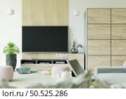 Furnished living room and wall mounted TV, 3D style. Стоковое фото, агентство Ingram Publishing / Фотобанк Лори