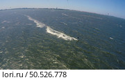 Aerial kite view of kitesurfer gliding across river on a windy day. Стоковое фото, агентство Ingram Publishing / Фотобанк Лори