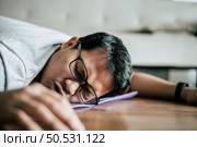 Funny overweight man in glasses closed his eyes and lying exhausted down on the floor after workout, copy space. Стоковое фото, агентство Ingram Publishing / Фотобанк Лори