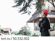 Portrait of Asian young woman in winter costume praying in the morning at the woodland. Christianity and faith hope love concept. Стоковое фото, агентство Ingram Publishing / Фотобанк Лори