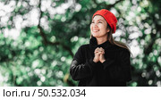 Portrait of Asian young woman in winter costume praying in the morning at the woodland. Christianity and faith hope love concept. Стоковое фото, агентство Ingram Publishing / Фотобанк Лори