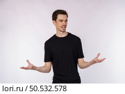 Portrait of puzzled clueless young man arms out asking why what’s the problem who cares so what, I don’t know on isolated background. Стоковое фото, агентство Ingram Publishing / Фотобанк Лори